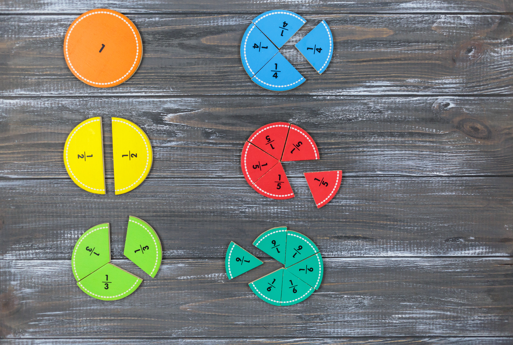 A grey background with colourful fractions on top.